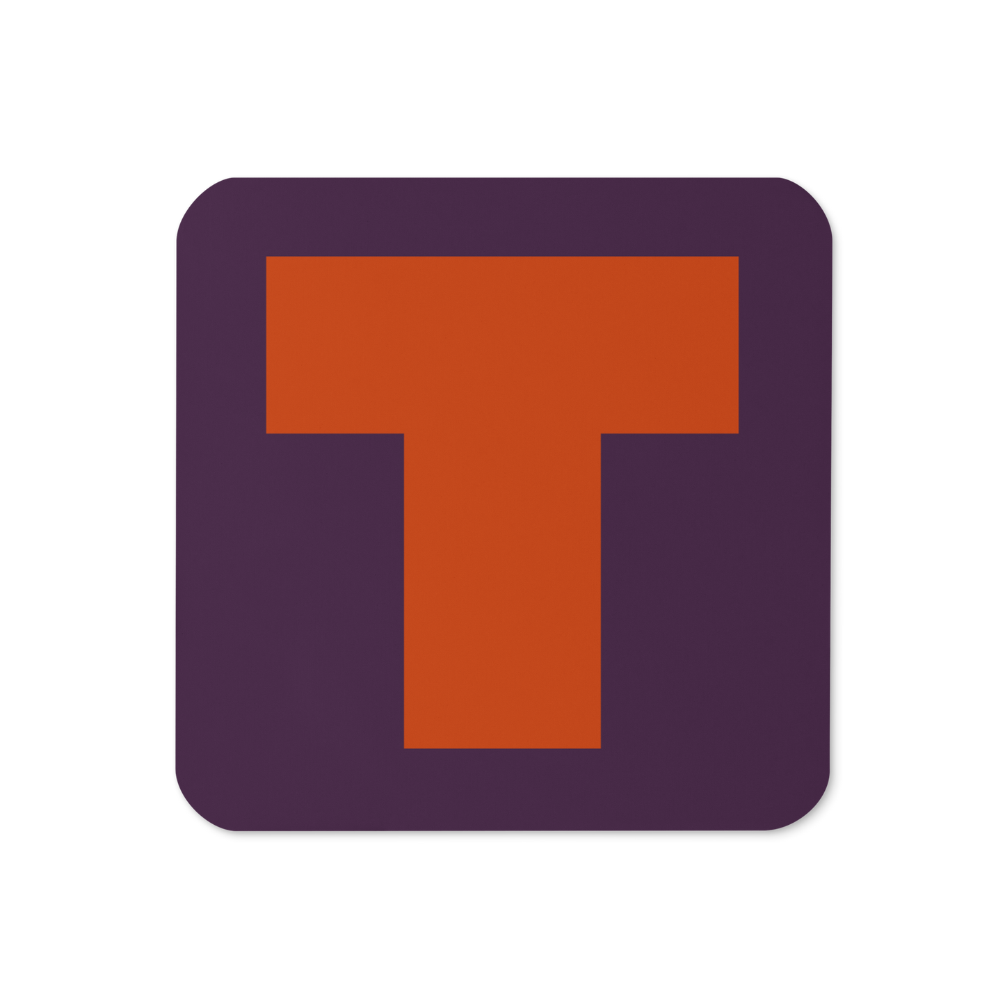 Cork-back coaster with a bold burnt orange fat font T letter on a plum purple background, graphic modern design.