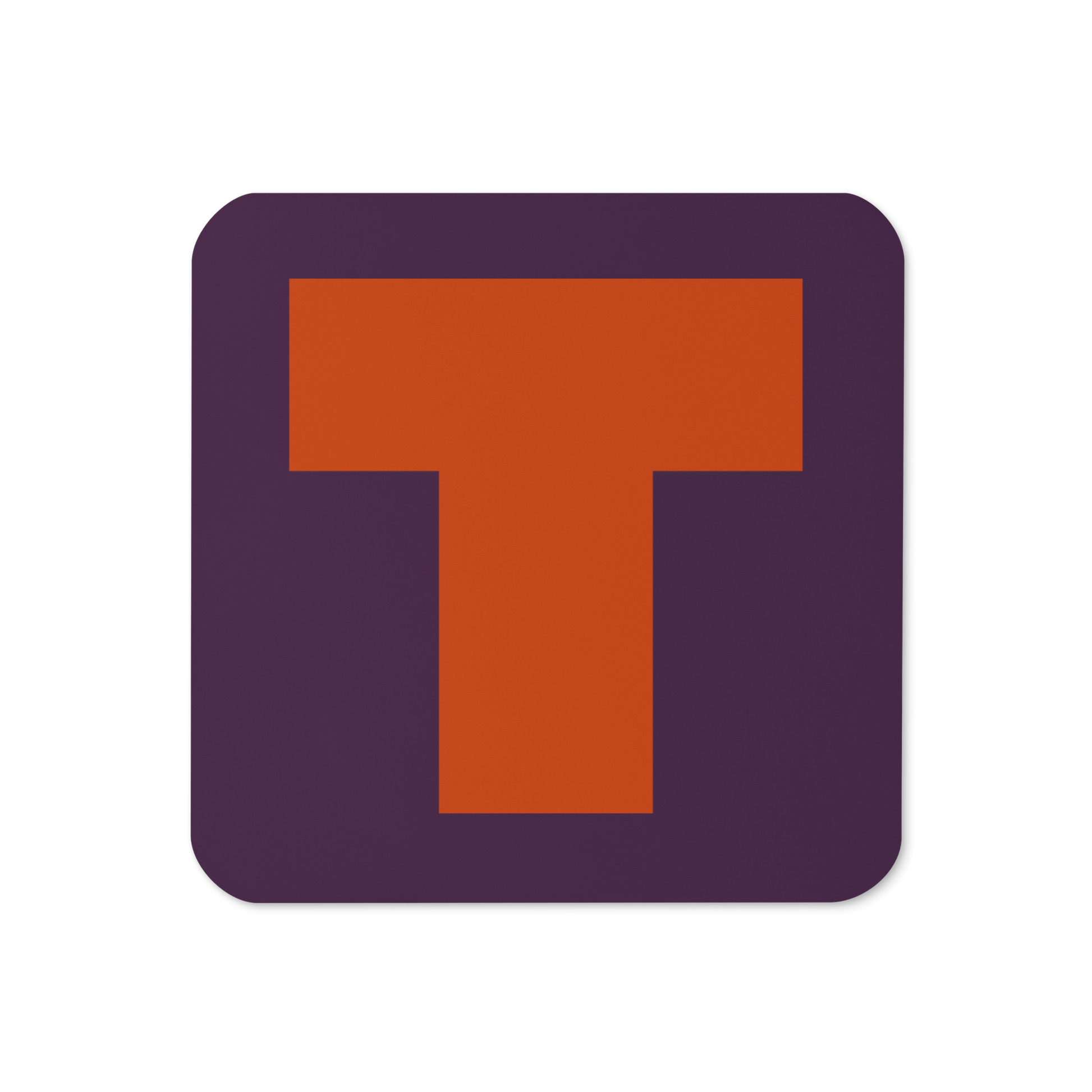 Cork-back coaster with a bold burnt orange fat font T letter on a plum purple background, graphic modern design.