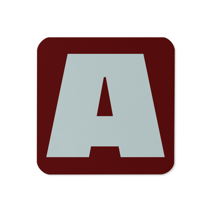 Cork-back coaster with a bold pale gray fat font A letter on a burgundy red background, graphic modern design.