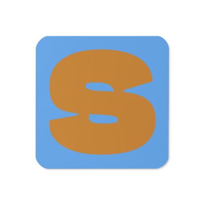 Cork-back coaster with a bold ochre fat font S letter on a sky blue background, graphic modern design.