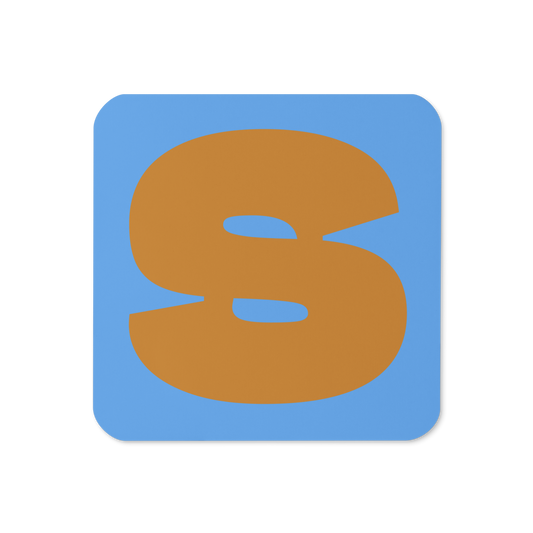Cork-back coaster with a bold ochre fat font S letter on a sky blue background, graphic modern design.